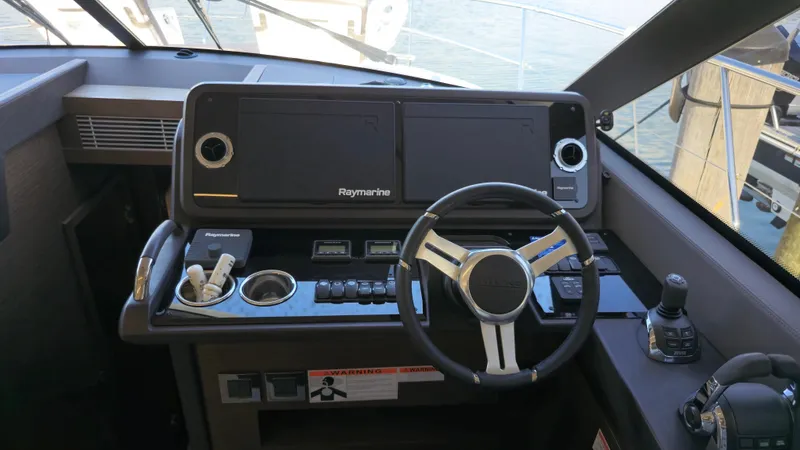 Slide: The Image of Helm of 2018 Prestige 460 yacht with Raymarine navigation system and steering wheel. - 27