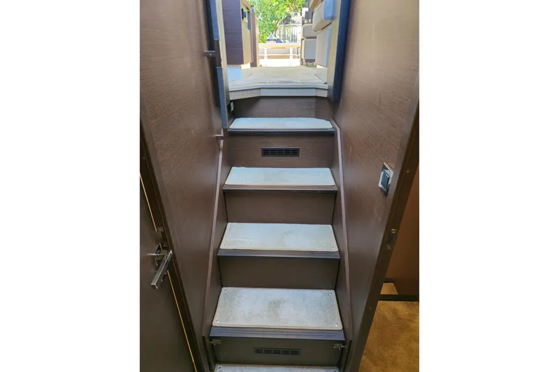 Slide: The Image of Staircase inside 2018 Prestige 460 yacht, leading to upper deck with outdoor view. - 28