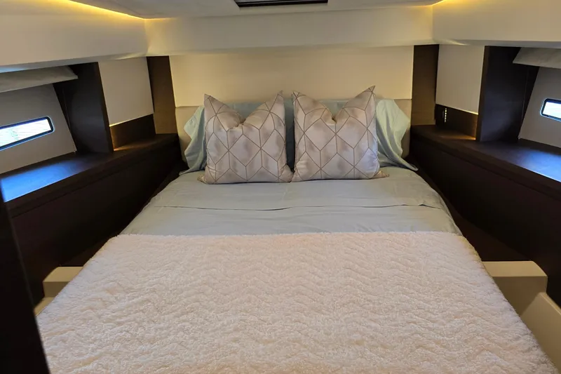 Slide: The Image of Luxurious bedroom interior of 2018 Prestige 460 yacht with elegant bedding and ambient lighting. - 30