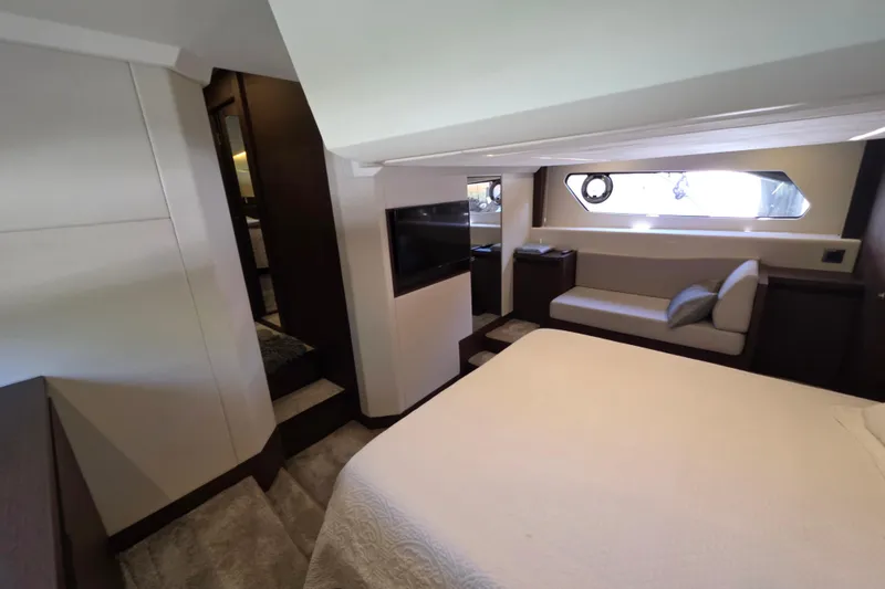 Slide: The Image of Luxurious interior of a 2018 Prestige 460 yacht, featuring a cozy bedroom and seating area. - 34