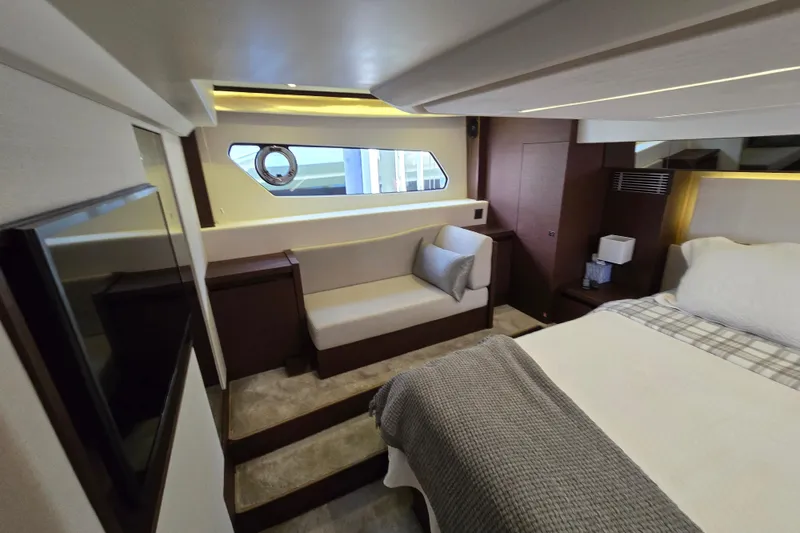 Slide: The Image of Luxurious interior of a 2018 Prestige 460 yacht, featuring a cozy bedroom and seating area. - 37
