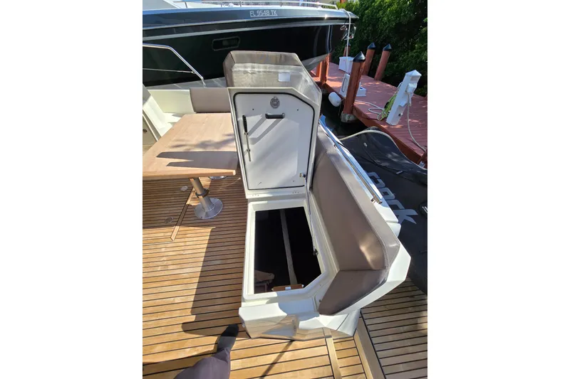 Slide: The Image of Open storage compartment on 2018 Prestige 460 yacht deck with wooden flooring. - 7