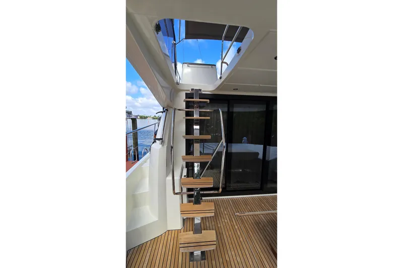 Slide: The Image of Staircase on 2018 Prestige 460 yacht with wooden steps and sleek design. - 9