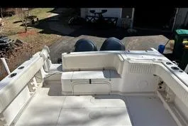 Slide: The Image of 1999 Grady-White Marlin 300 boat deck with twin engines, parked outdoors. - 10