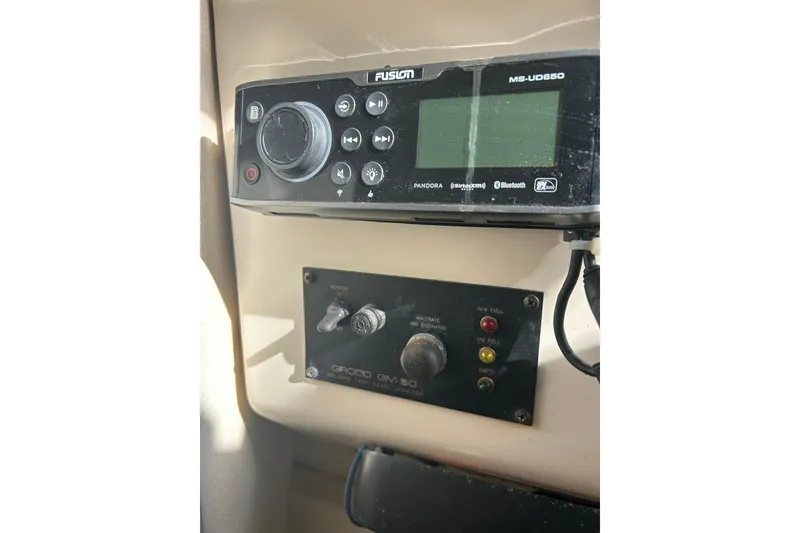 Slide: The Image of Control panel on a 1999 Grady-White Marlin 300 boat, featuring Fusion MS-UD650 stereo. - 16