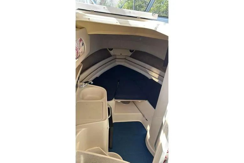 Slide: The Image of 1999 Grady-White Marlin 300 cabin interior with seating and compact amenities. - 17