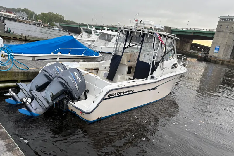 Slide: The Image of 1999 Grady-White Marlin 300 boat docked with twin Yamaha outboard engines. - 2