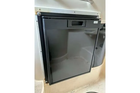 Slide: The Image of Built-in refrigerator on a 1999 Grady-White Marlin 300 boat interior. - 20