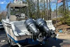 Slide: The Image of 1999 Grady-White Marlin 300 boat with dual outboard motors, parked outdoors. - 27