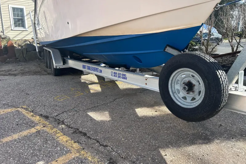 Slide: The Image of 1999 Grady-White Marlin 300 boat on trailer, parked on asphalt. - 29