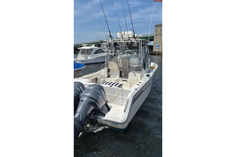 Slide: The Image of 1999 Grady-White Marlin 300 boat with dual Yamaha engines docked in a marina. - 3