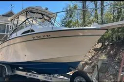 Slide: The Image of 1999 Grady-White Marlin 300 boat on trailer, parked outdoors. - 4