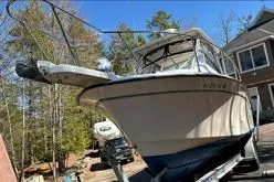 Slide: The Image of 1999 Grady-White Marlin 300 boat on trailer, surrounded by trees and houses. - 5