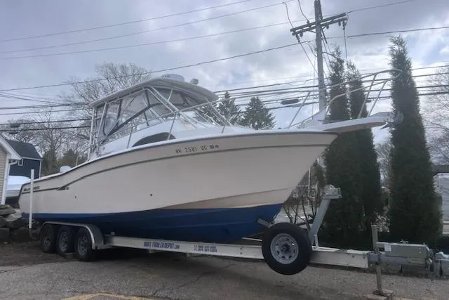 Slide: The Image of 1999 Grady-White Marlin 300 boat on trailer, parked outdoors. - 7