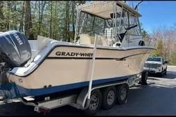 Slide: The Image of 1999 Grady-White Marlin 300 boat on trailer, parked outdoors. - 8