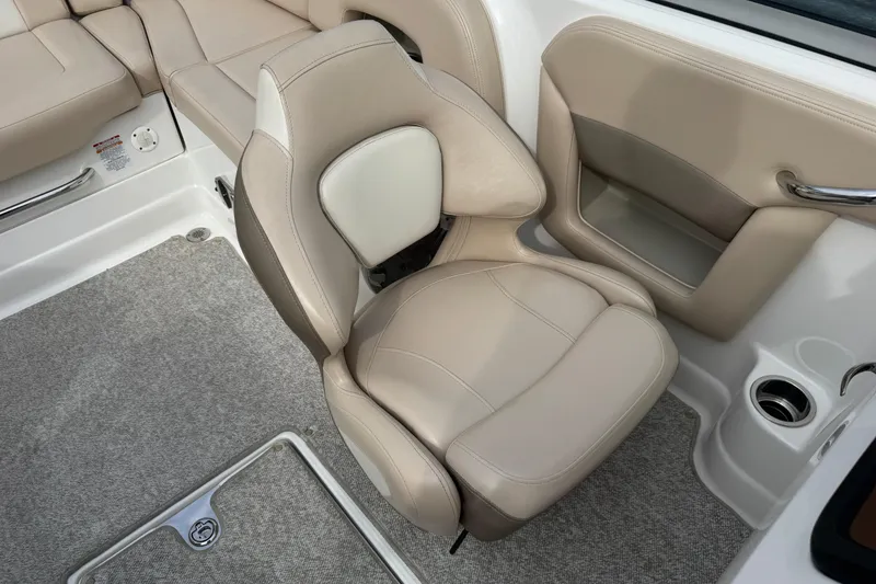 Slide: The Image of Beige seating in 2012 Chaparral 224 Sunesta boat interior, featuring cup holder and carpeted floor. - 15