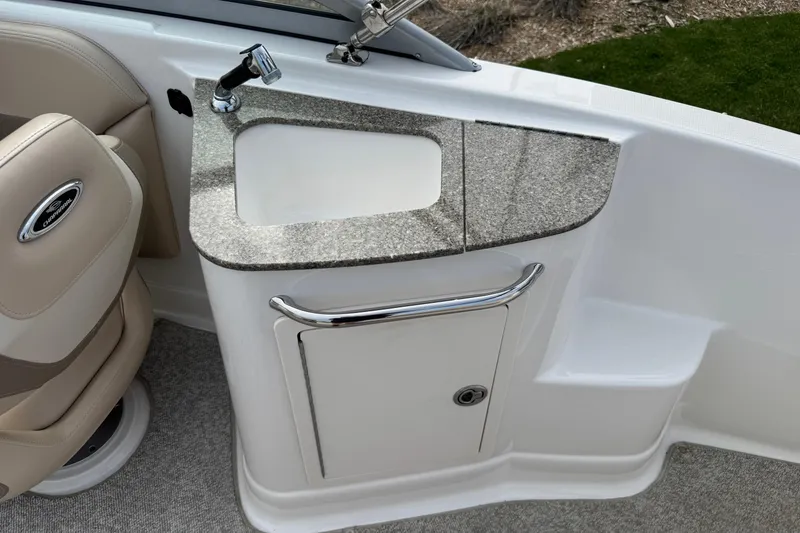 Slide: The Image of 2012 Chaparral 224 Sunesta boat interior with sink and seating area. - 17