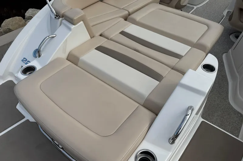 Slide: The Image of 2012 Chaparral 224 Sunesta boat interior with beige seating and cup holders. - 23