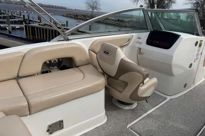 Slide: The Image of Interior of 2012 Chaparral 224 Sunesta boat with beige seating and helm. - 25