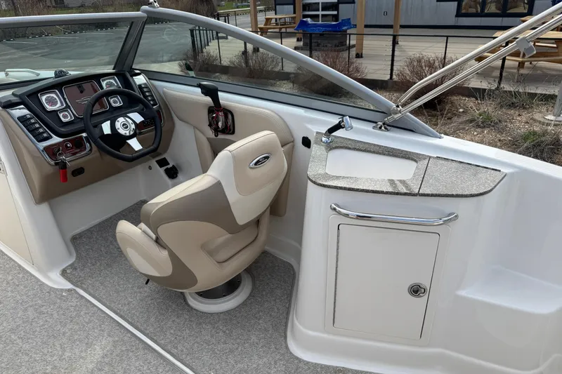 Slide: The Image of 2012 Chaparral 224 Sunesta boat interior with steering wheel and dashboard controls. - 27