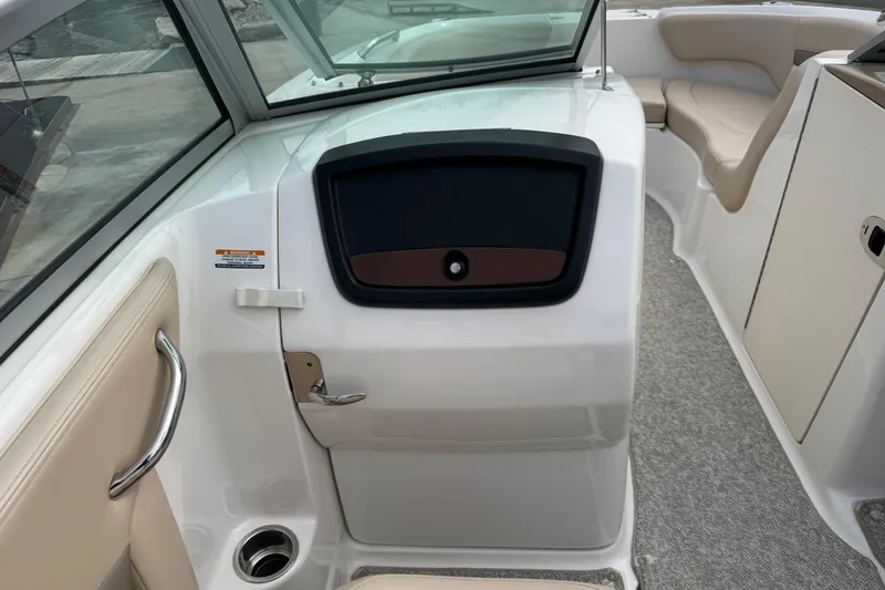 Slide: The Image of 2012 Chaparral 224 Sunesta boat interior with seating and storage compartment. - 29