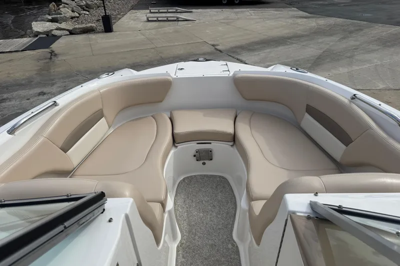 Slide: The Image of 2012 Chaparral 224 Sunesta boat interior with beige seating and carpeted floor. - 31