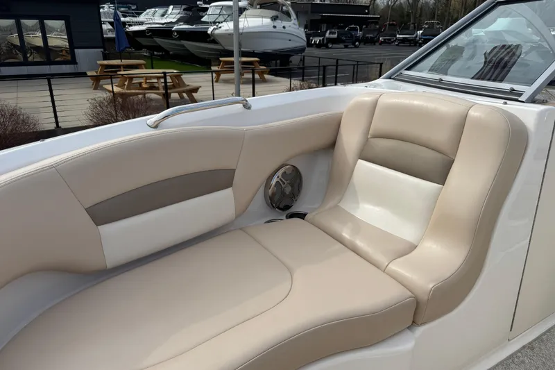 Slide: The Image of 2012 Chaparral 224 Sunesta boat interior with beige seating and speaker detail. - 32