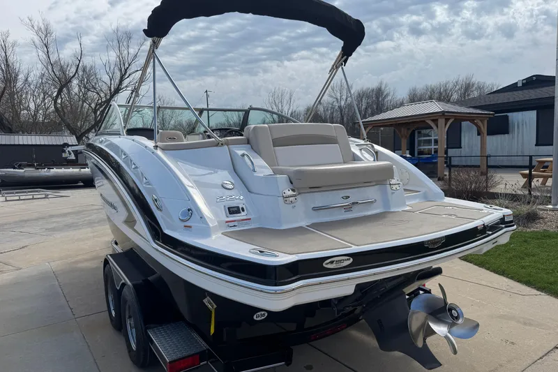 Slide: The Image of 2012 Chaparral 224 Sunesta boat on trailer, featuring sleek design and spacious deck. - 4