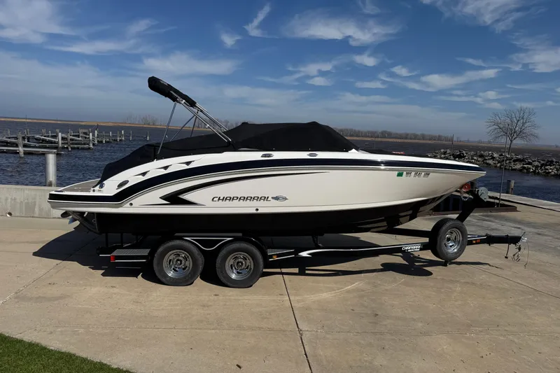 Slide: The Image of 2012 Chaparral 224 Sunesta boat on trailer by waterfront under blue sky. - 7