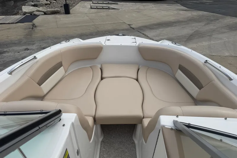 Slide: The Image of 2012 Chaparral 224 Sunesta boat interior with beige seating and spacious layout. - 9