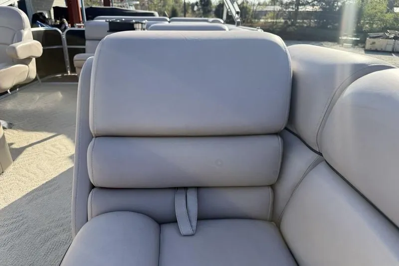 Slide: The Image of 2013 South Bay 422 CR boat interior storage compartment with cushioned seating and carpeted flooring. - 13