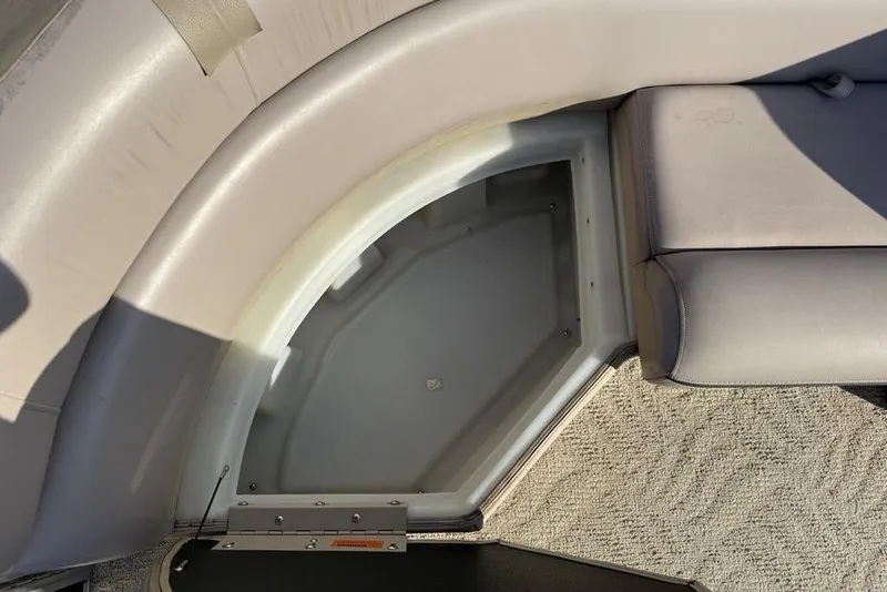 Slide: The Image of 2013 South Bay 422 CR boat storage compartment with beige door and chrome handle. - 14