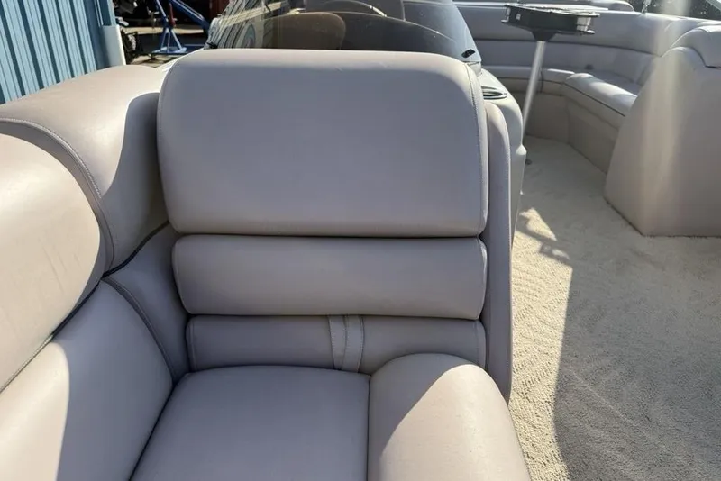 Slide: The Image of Open storage compartment in 2013 South Bay 422 CR boat with cushioned seating. - 17