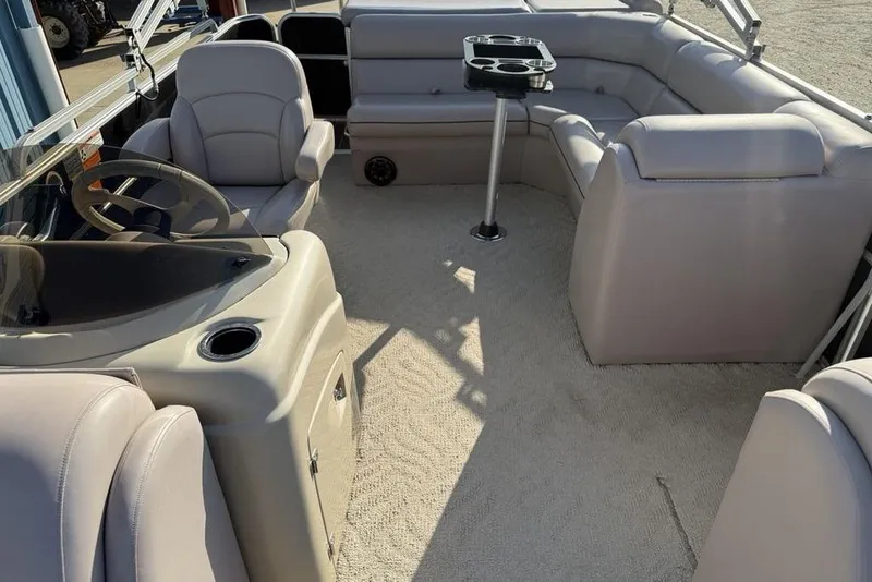 Slide: The Image of Captain's chair on 2013 South Bay 422 CR pontoon boat, beige upholstery, steering wheel visible. - 19