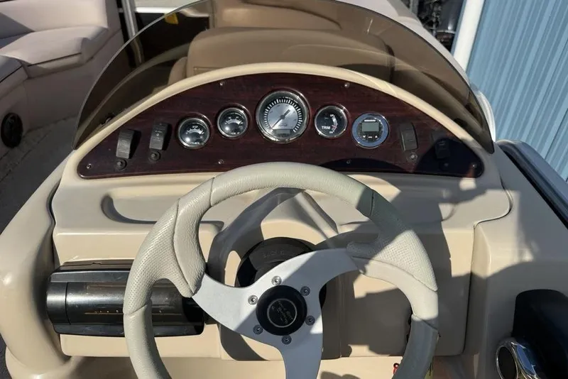 Slide: The Image of Close-up of 2013 South Bay 422 CR boat throttle and steering wheel with safety whistle. - 24