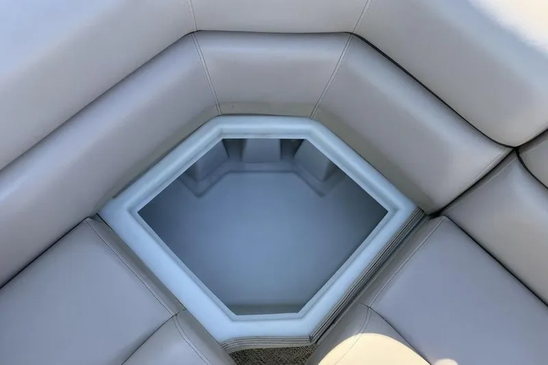 Slide: The Image of 2013 South Bay 422 CR boat storage compartment with cup holders, beige interior. - 31