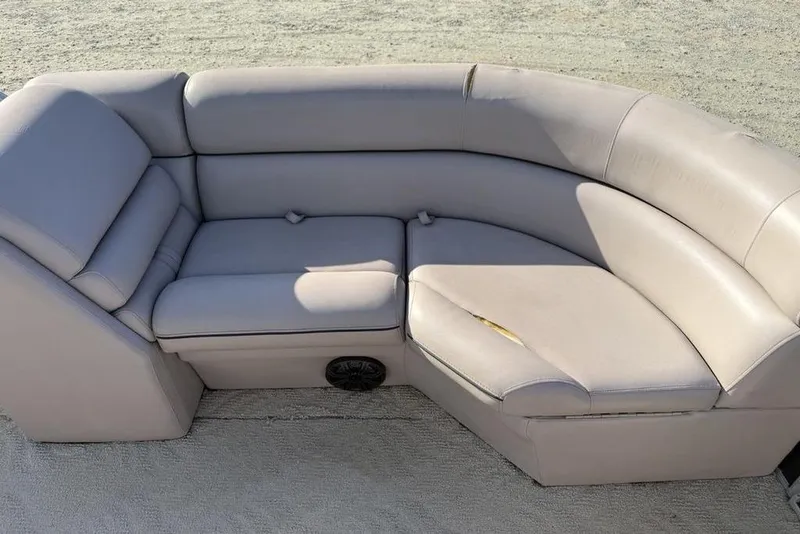 Slide: The Image of 2013 South Bay 422 CR boat seating with beige upholstery and speaker, against blue wall. - 33
