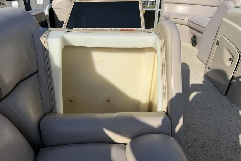 Slide: The Image of 2013 South Bay 422 CR boat interior storage compartment with beige seating. - 35