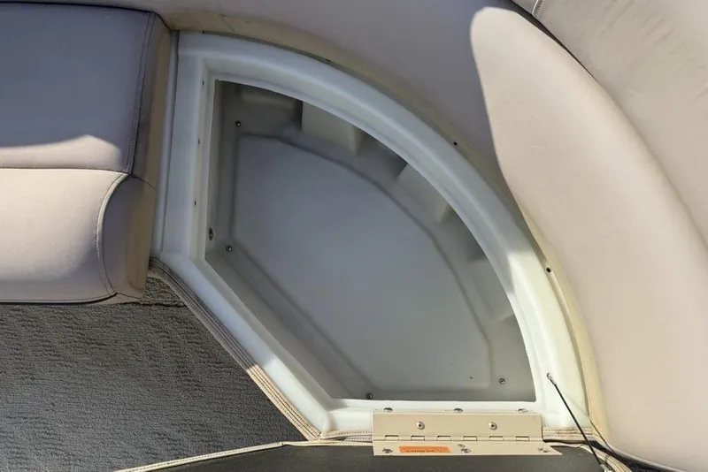 Slide: The Image of Storage compartment in a 2013 South Bay 422 CR boat, featuring beige upholstery. - 36