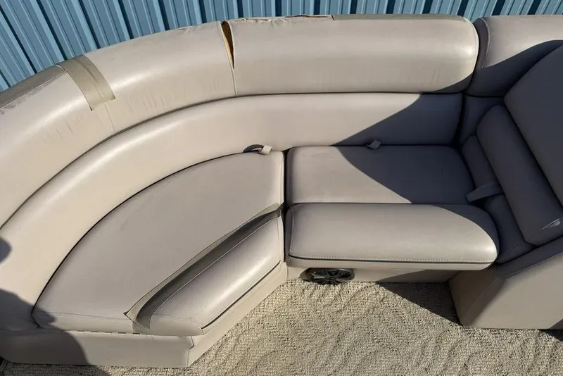 Slide: The Image of Interior of 2013 South Bay 422 CR pontoon boat with beige seating and steering console. - 9