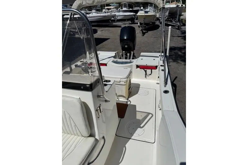 Slide: The Image of 2013 Tideline 190 boat interior with seating and motor, parked on a lot. - 10