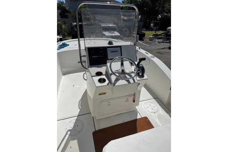 Slide: The Image of Center console of a 2013 Tideline 190 boat with steering wheel and navigation equipment. - 12