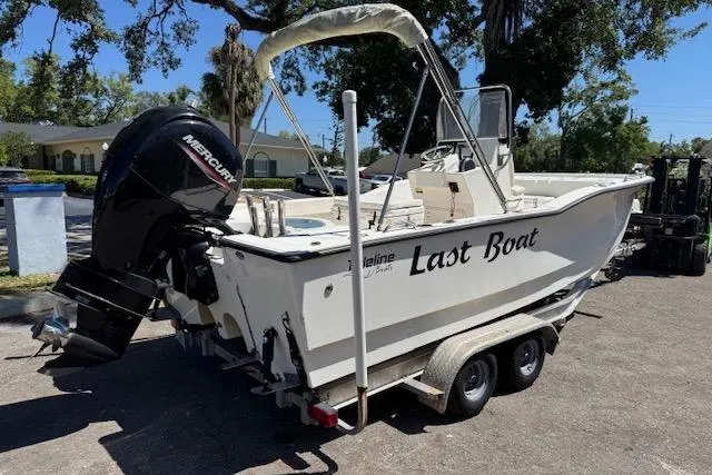 Slide: The Image of 2013 Tideline 190 boat on trailer with Mercury outboard motor, labeled "Last Boat." - 3
