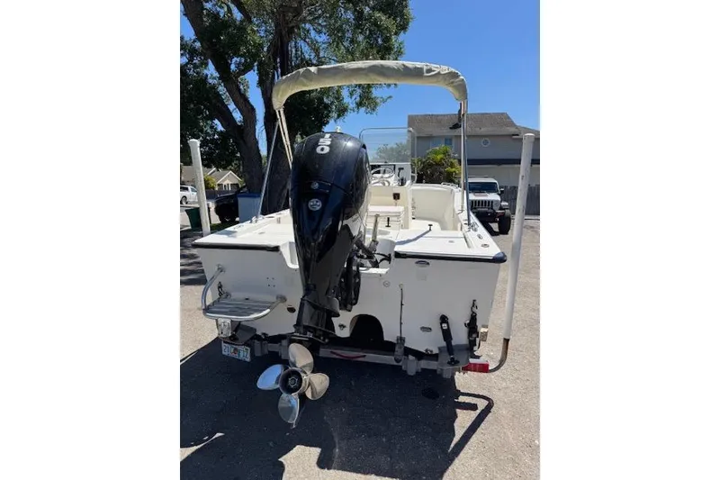 Slide: The Image of 2013 Tideline 190 boat with outboard motor, parked on a sunny street. - 4