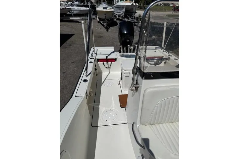 Slide: The Image of 2013 Tideline 190 boat interior with seating and control panel, docked outdoors. - 9