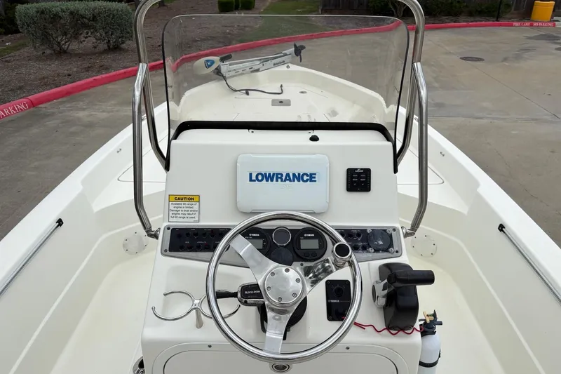 Slide: The Image of 2015 Skeeter SX2250 boat dashboard with steering wheel and Lowrance electronics. - 4