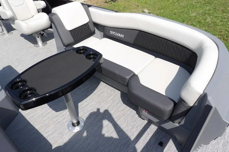 Slide: The Image of 2026 Sylvan R-20 PARTY FISH boat interior with cushioned seating and table. - 13
