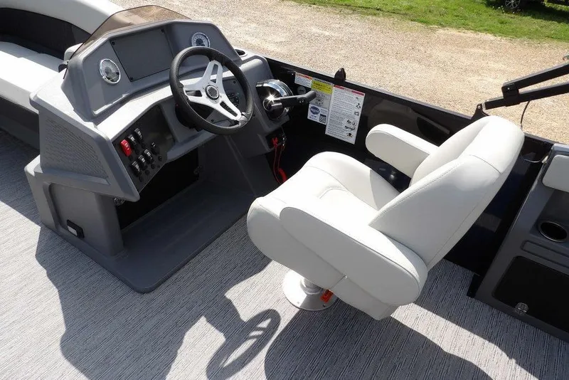 Slide: The Image of 2026 Sylvan R-20 PARTY FISH boat interior with steering wheel and captain's chair. - 19