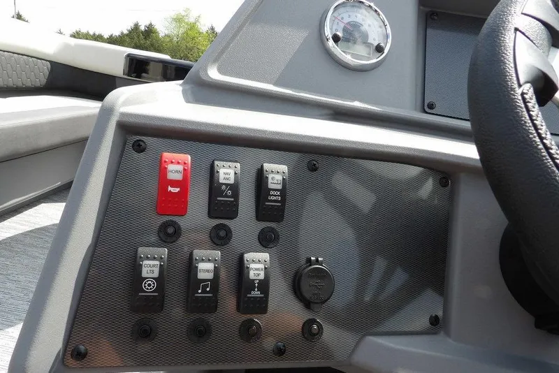 Slide: The Image of Control panel of 2026 Sylvan R-20 PARTY FISH boat with various switches and gauges. - 21