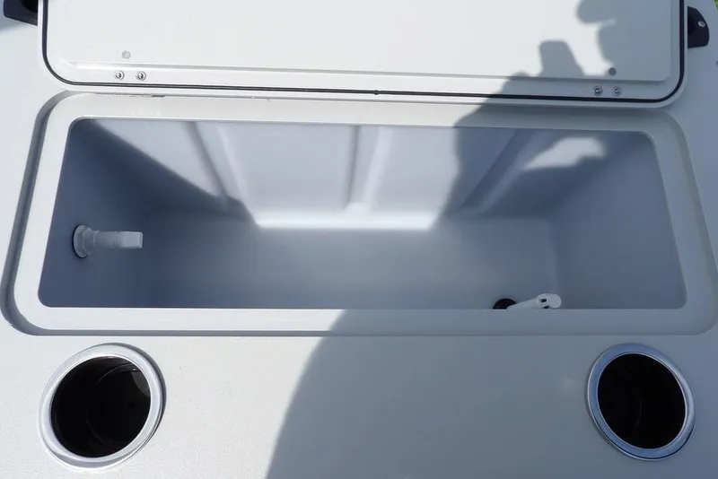 Slide: The Image of Open storage compartment on 2026 Sylvan R-20 PARTY FISH boat, featuring cup holders. - 22
